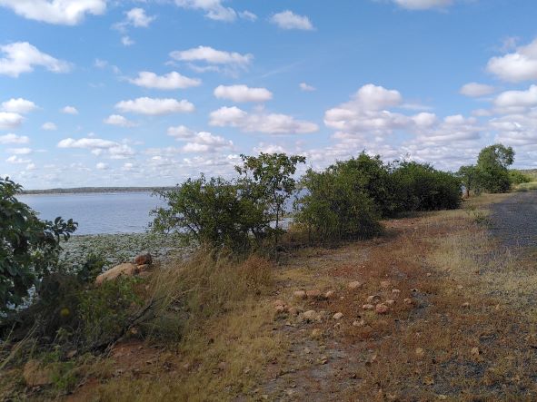 View of a dam and dam wall with hills in the background